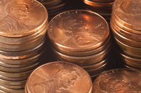 Stacks of copper pennies have a red-pink color.