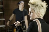 Two musicians performing in a recording studio.