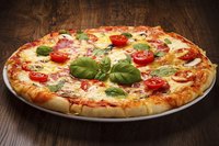Both fresh and dried herbs can contribute to a pizza's seasoning.