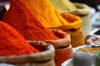 In India, curry spices are piled high at outdoor markets.