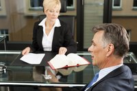 Client sitting at table with lawyer