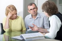 A couple is with a divorce attorney.