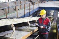 An inspector checking sugar as it moves down the production line.