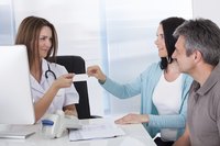 Couple making a payment at an urgent care center.