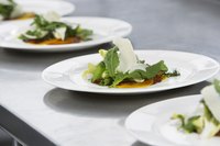 Three small salads on little white plates