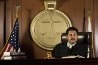 Judge sitting in courtroom.