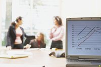Graph on a laptop in a meeting room