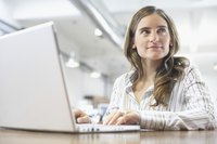 Woman typing on laptop at work.