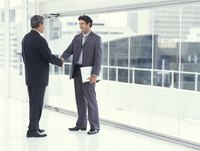 Two businessmen shaking hands in a modern office
