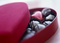 A heart shaped container of chocolates.