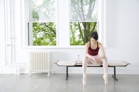 Young ballerina sitting in her studio