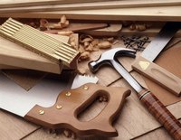 Saw and hammer on pieces of wood.