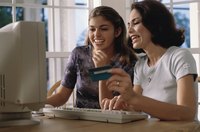 Mother and daughter with credit card shopping on a computer.