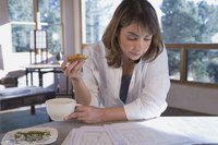 A woman is eating a slice of toast.