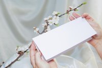 Image of a woman opening an invitation.