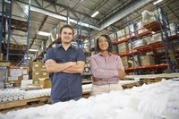 Factory managers standing next to an assembly line