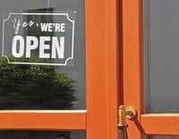 "Open" sign on storefront window.