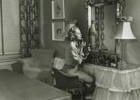 A vintage bedroom with a skirted dressing table.
