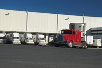 Trucks are docked at shipping bays.