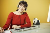 A customer service agent is at work wearing a headset.
