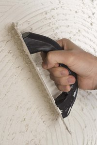 Apply Grout Enhancer with a rubber float.