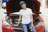 A female mechanic is working on a vehicle.