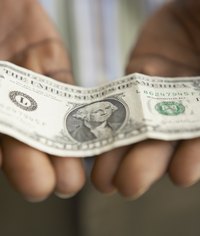 Close-up of dollar bill in woman's hands.
