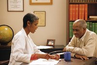 A doctor is sitting with a patient.