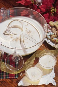 A warm glass of Tom and Jerry paired with Christmas cookies makes a festive treat.