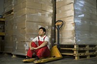Warehouse worker next to a stack of boxes