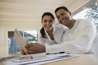 A man and woman are using a laptop together.