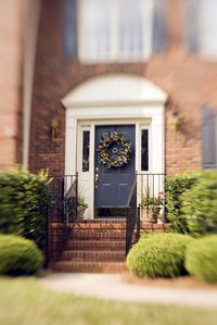 Paint color choices can make a front door look small or large.