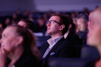 Guests listening to a seminar in an auditorium.