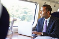 An employee using remote access to work from a train.