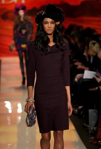 A mulit-colored clutch is a stylish accent piece with a burgundy dress.