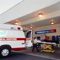 An ambulance is backed up to a hospital door.