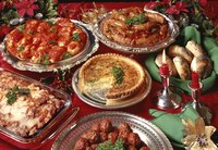 Assorted holiday buffet dishes on a red tablecloth.