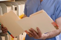 A doctor looks at medical records