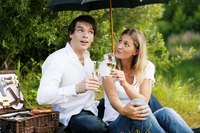 Couple having a picnic under an umbrella.