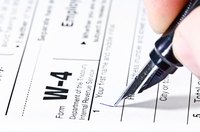 Pen writing on a W-4 form
