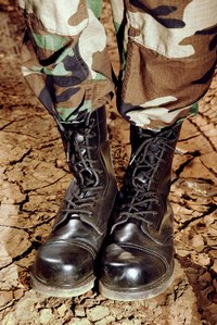 Transform a pair of army boots into a set fit for a professional wrestler.