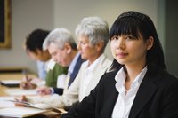 Collegues taking notes during a business meeting.