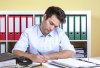 Young businessman writing a proposal