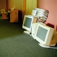 Old computers and monitors on the floor