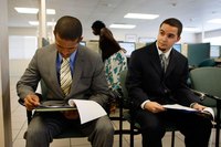 Two job candidates waiting in an office for an interview.