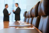 Executives having a discussion in a boardroom.