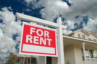 A house stands for rent with a large 'For Rent' sign clearly visible to passersby
