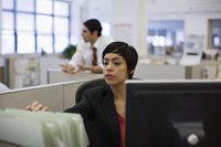 Woman working on desktop in office.