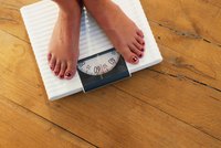 Woman's feet standing on scale