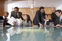Large business meeting taking place in office.
